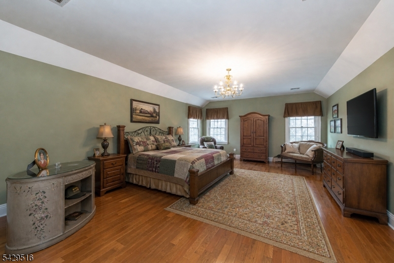 107 Clove Road, Unit 3 Wantage, NJ 07461 - Photo 22 of 45 a spacious bedroom with a bed and a flat screen television