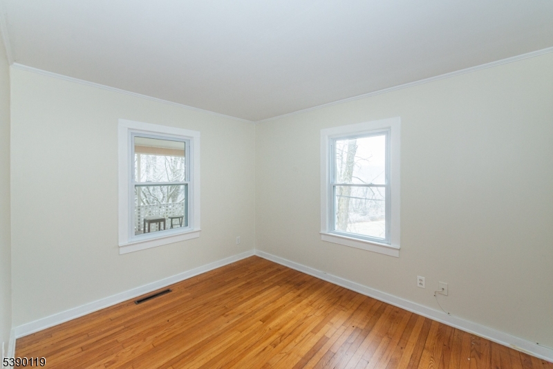 107 Clove Road, Unit 3 Wantage, NJ 07461 - Photo 33 of 45 an empty room with wooden floor and windows