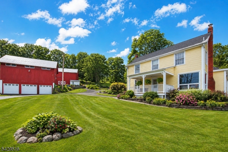 107 Clove Road, Unit 3 Wantage, NJ 07461 - Photo 4 of 45 a view of a house with a big yard potted plants and large tree
