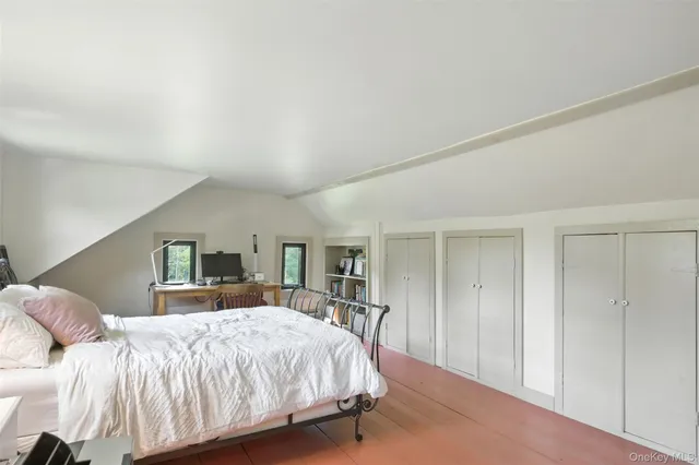 a bed room with a bed and a large mirror