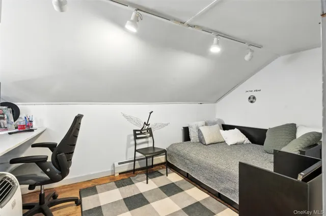 a bedroom with a bed a desk and chair