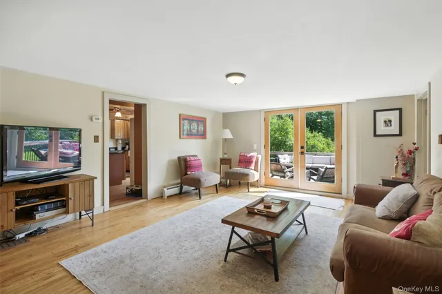 a living room with furniture a rug and a flat screen tv