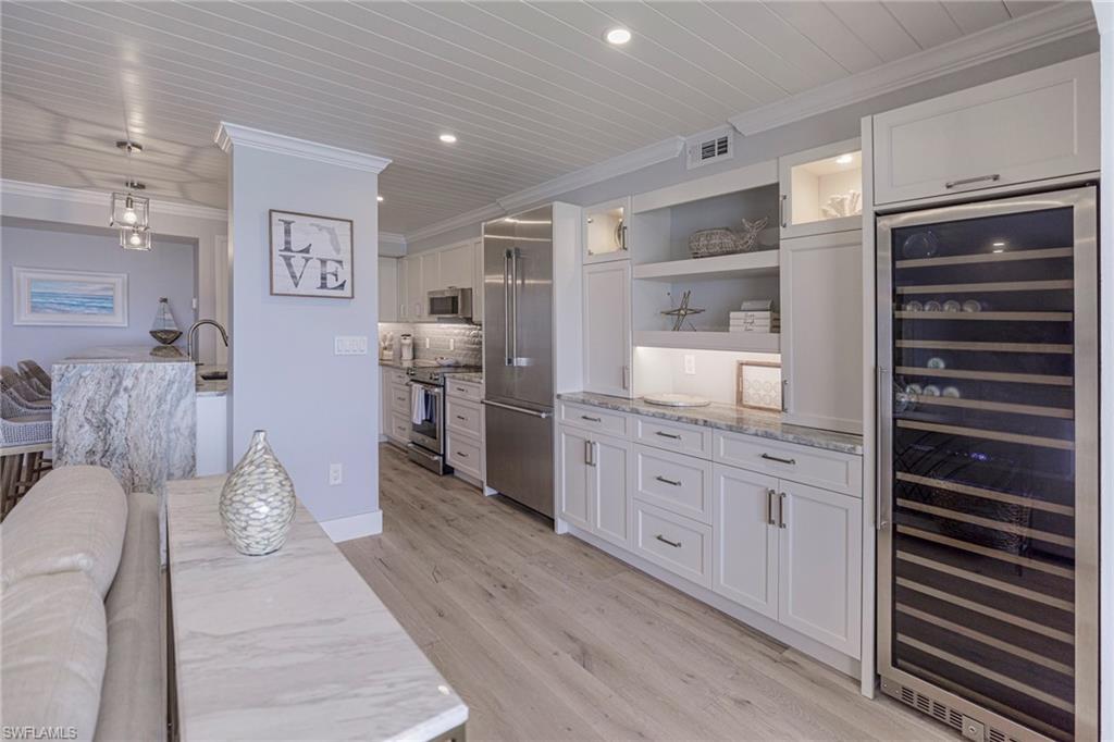 250 Park Shore Drive, Unit 302 Naples, FL 34103 - Photo 11 of 35 a room with furniture a rug and white walls