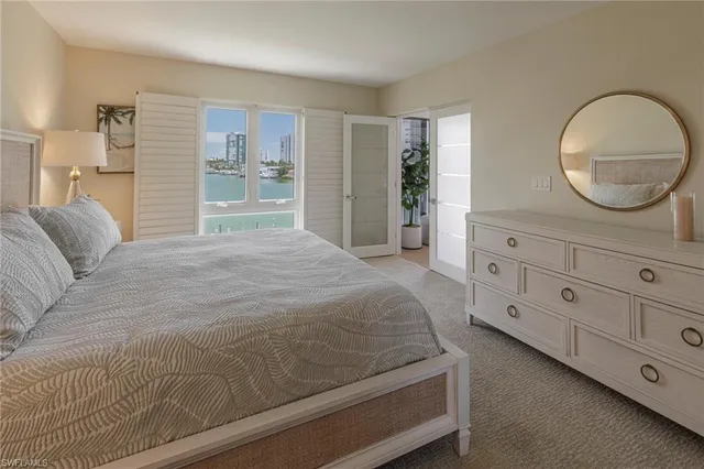 a bedroom with a large bed and a dresser