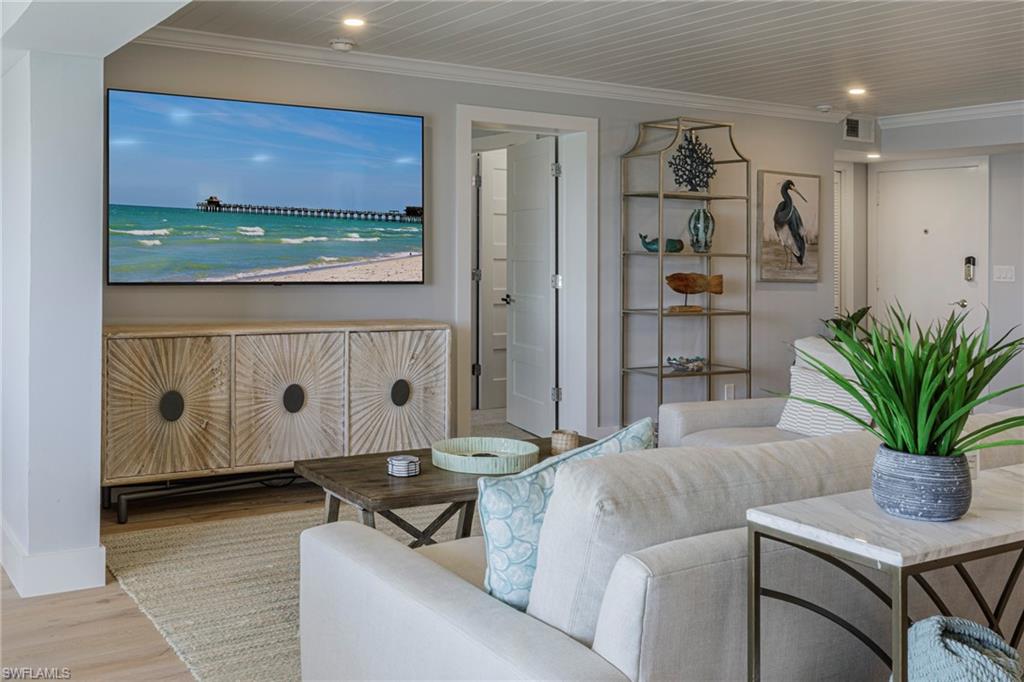 250 Park Shore Drive, Unit 302 Naples, FL 34103 - Photo 22 of 35 a living room with furniture and a potted plant