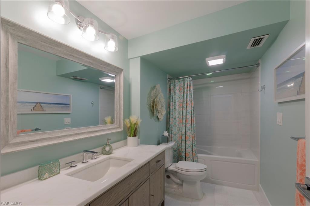 250 Park Shore Drive, Unit 302 Naples, FL 34103 - Photo 25 of 35 a bathroom with a sink a toilet and shower