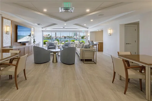 a living room with lots of furniture and a large window