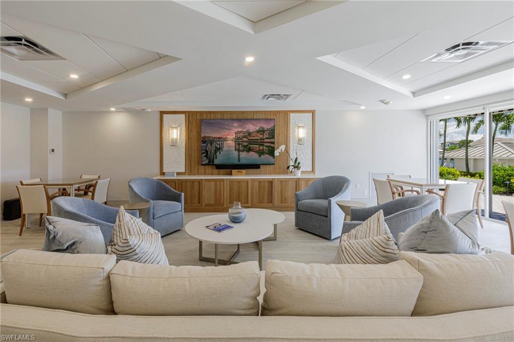 250 Park Shore Drive, Unit 302 Naples, FL 34103 - Photo 29 of 35 a living room with furniture and a large window