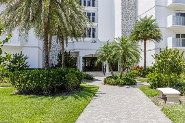 a front view of a house with a garden and plants