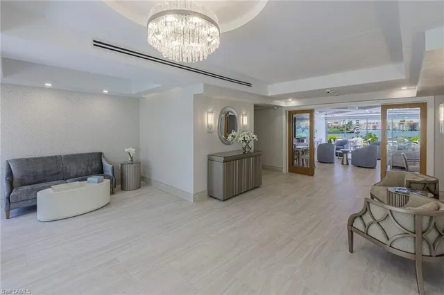 a living room with furniture and a chandelier