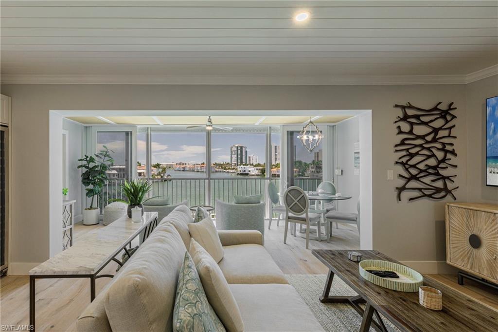 250 Park Shore Drive, Unit 302 Naples, FL 34103 - Photo 6 of 35 a living room with furniture and a floor to ceiling window
