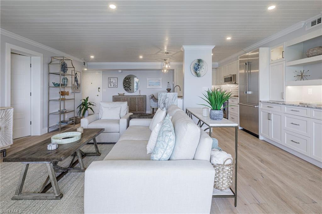 250 Park Shore Drive, Unit 302 Naples, FL 34103 - Photo 9 of 35 a living room with furniture and wooden floor