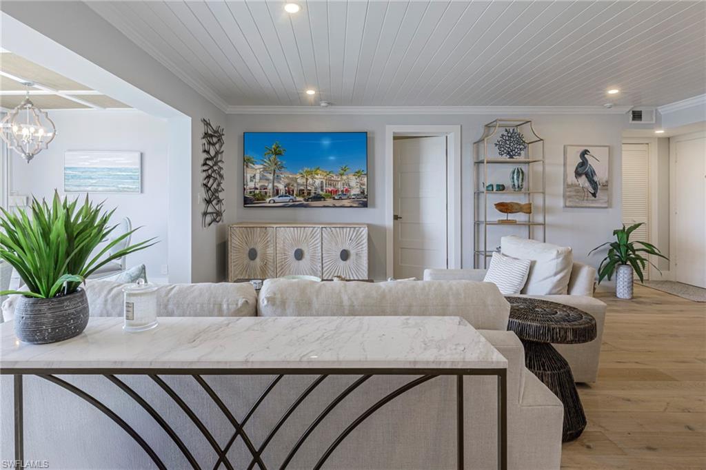 250 Park Shore Drive, Unit 302 Naples, FL 34103 - Photo 10 of 35 a living room with furniture and a potted plant