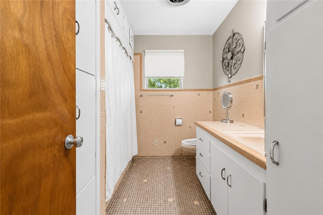 9675 County Road 325 Mathis, TX 78368 - Photo 23 of 29 a bathroom with a sink a toilet and a shower