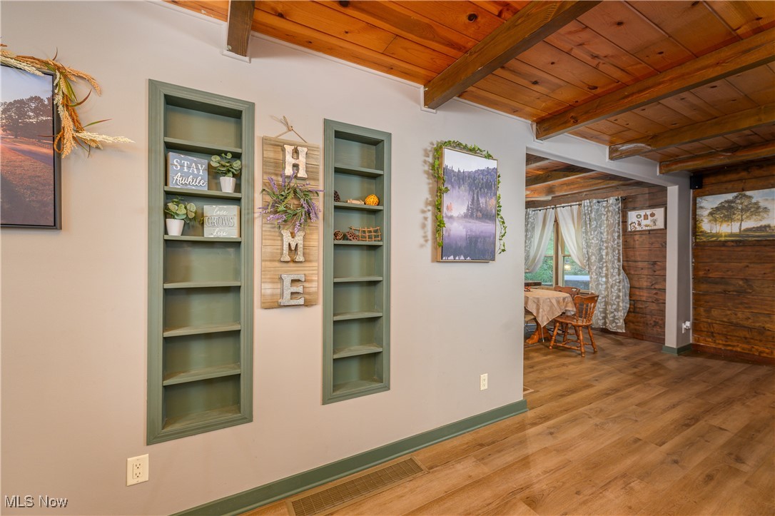 33201 Host Road Bowerston, OH 44695 - Photo 13 of 30 Hallway featuring wood-type flooring, beamed ceiling, wood ceiling, and built in shelves
