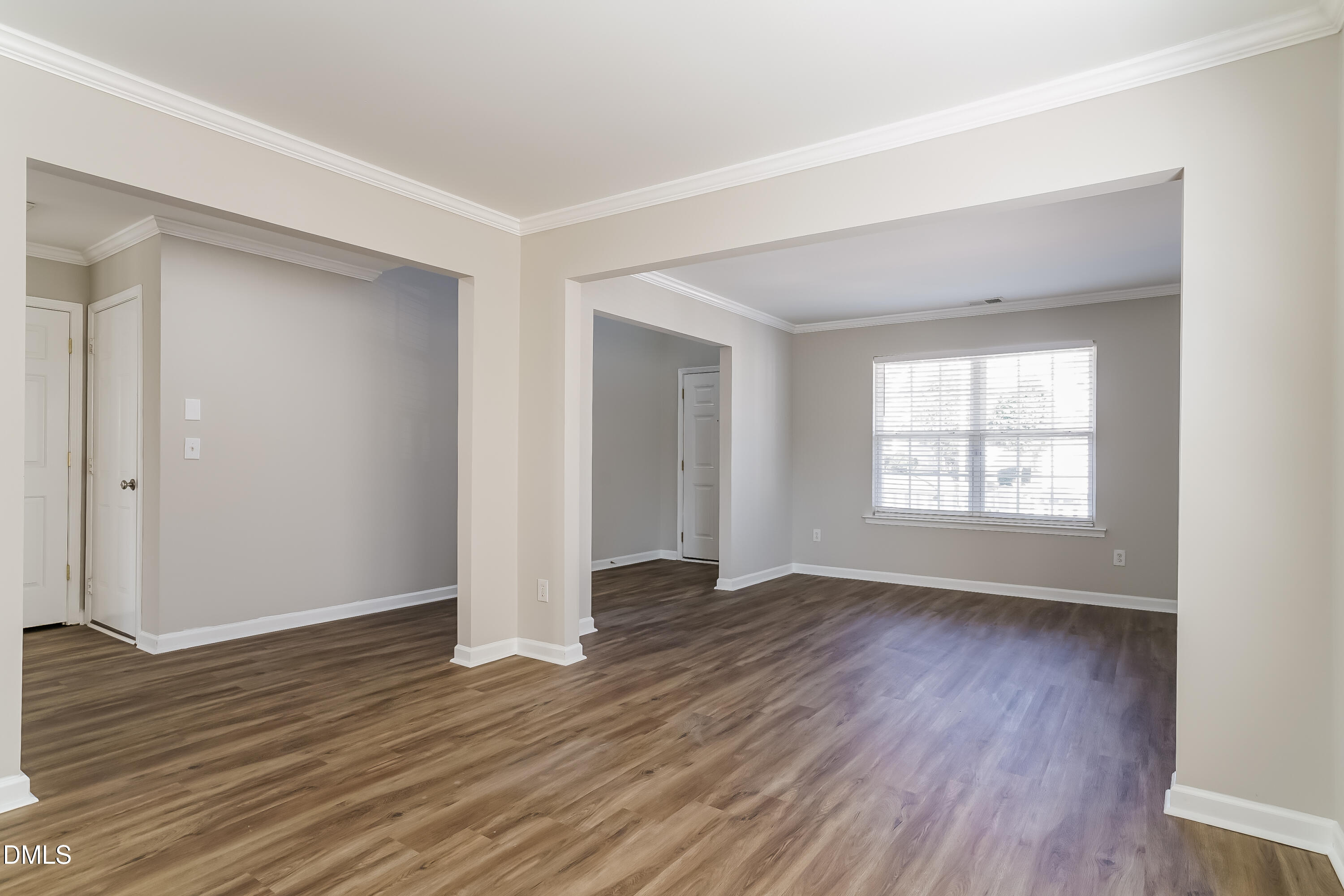 3567 Futura Lane Raleigh, NC 27610 - Photo 4 of 15 an empty room with wooden floor and windows
