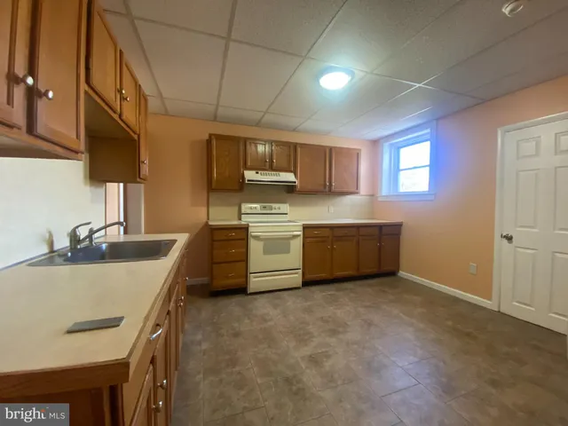 a kitchen with a sink stove and cabinets