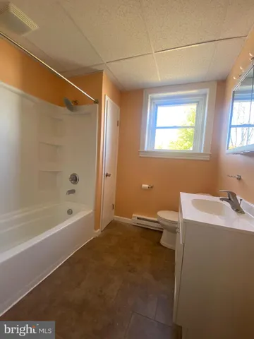 a bathroom with a bathtub and a sink