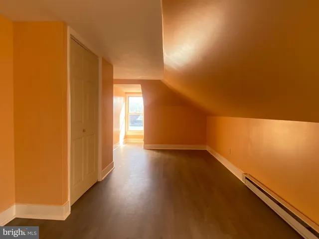 a view of an empty room and wooden floor