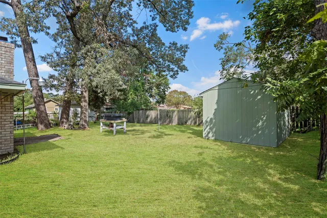 a backyard of a house with table and chairs