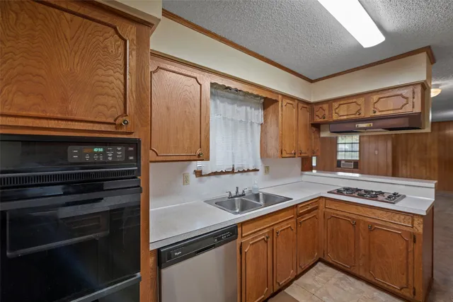 a kitchen with stainless steel appliances granite countertop a stove and a microwave