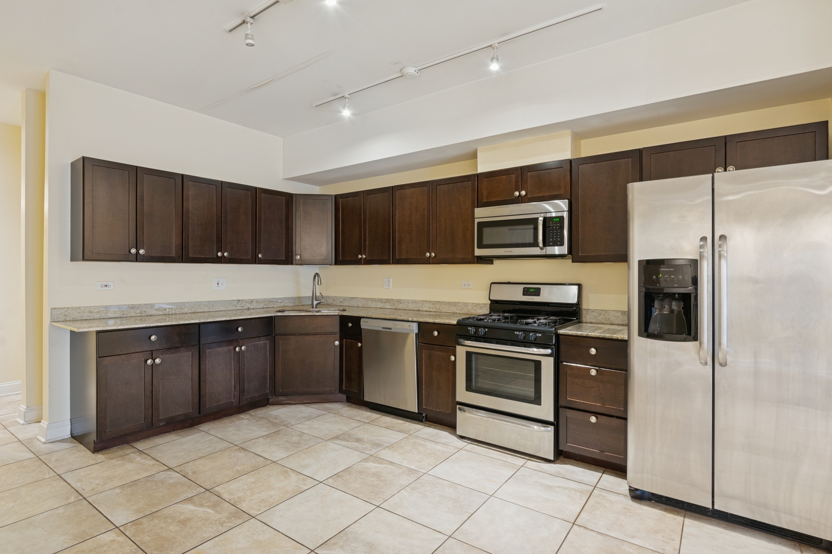 2801 West Ardmore Avenue, Unit 1A Chicago, IL 60659 - Photo 14 of 22 a kitchen with stainless steel appliances granite countertop a stove a sink dishwasher a refrigerator and a microwave oven