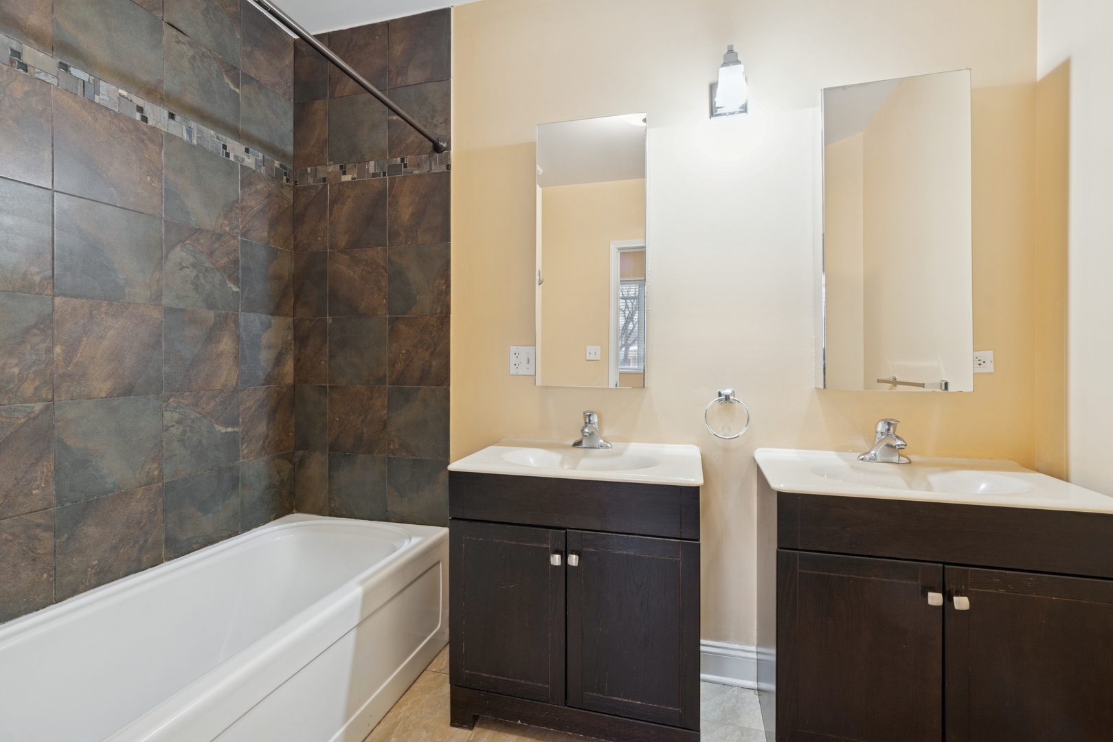 2801 West Ardmore Avenue, Unit 1A Chicago, IL 60659 - Photo 15 of 22 a bathroom with a sink double vanity and a bathtub