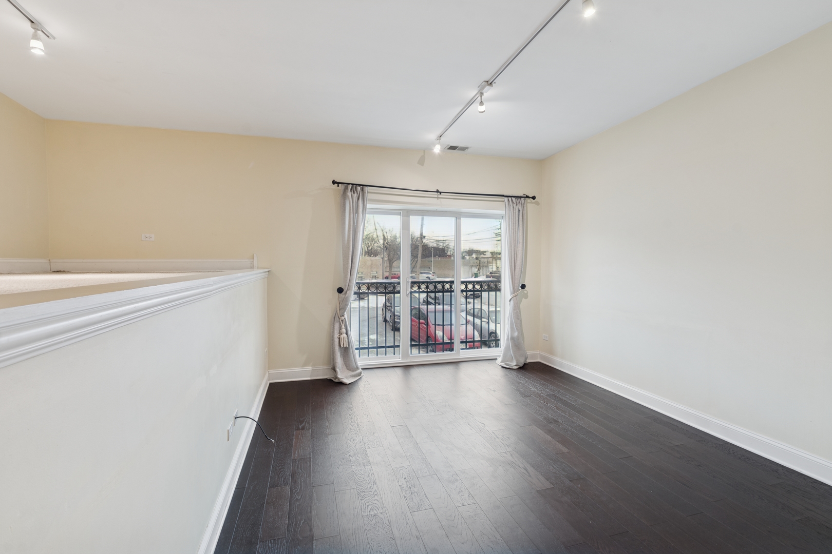 2801 West Ardmore Avenue, Unit 1A Chicago, IL 60659 - Photo 22 of 22 a view of an empty room with wooden floor and a window