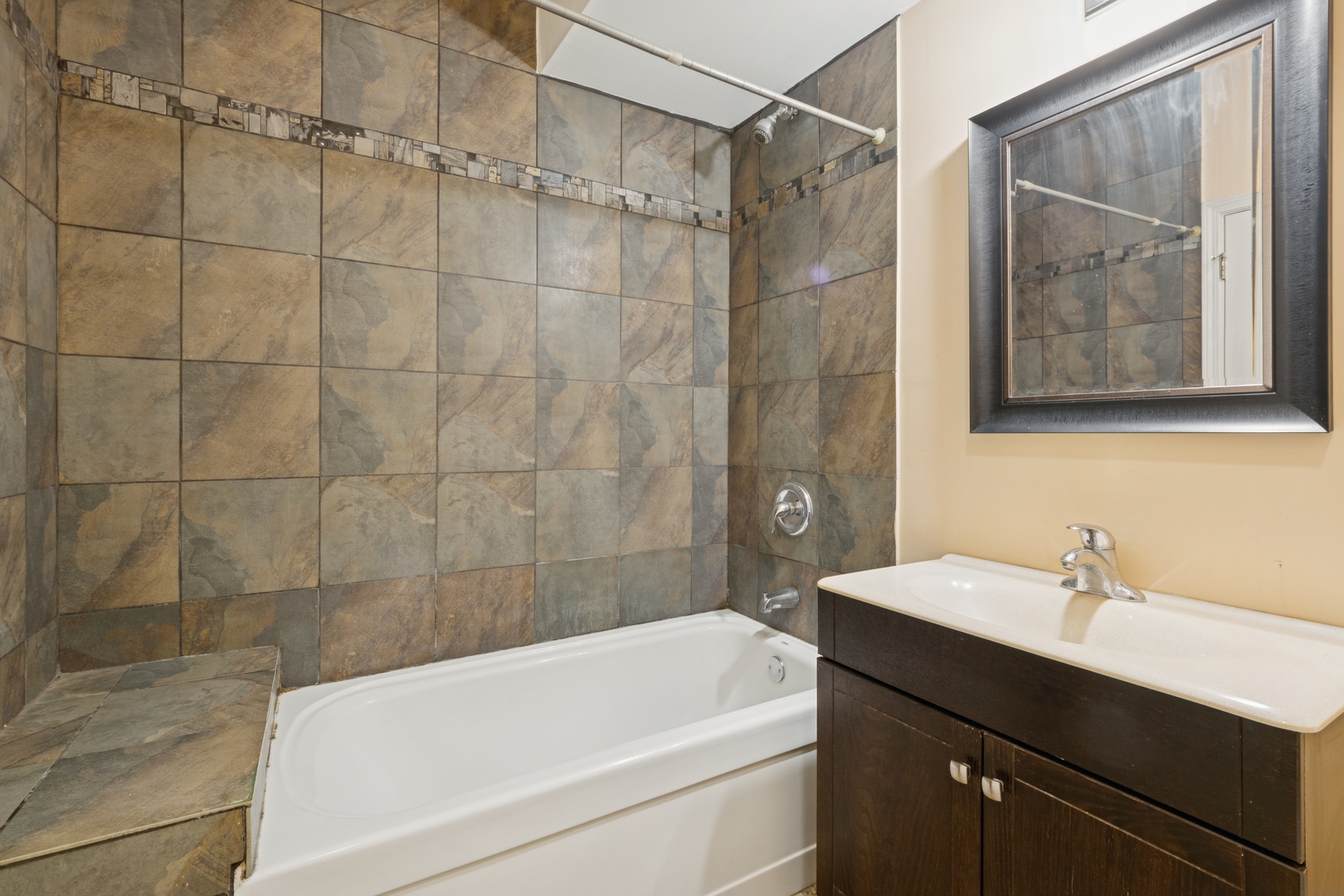 2801 West Ardmore Avenue, Unit 1A Chicago, IL 60659 - Photo 6 of 22 a bathroom with a sink and a bathtub