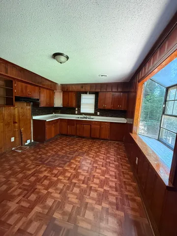 a room with wooden floor and window