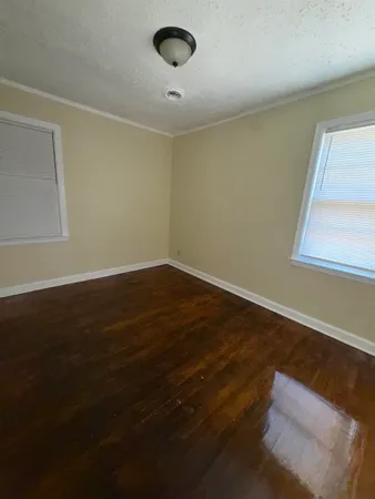 a view of wooden floor and windows in a room