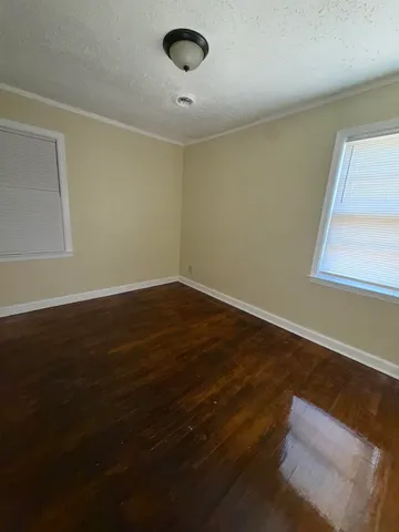 a view of wooden floor and windows in a room