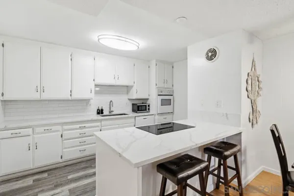 a kitchen with cabinets appliances and a center island