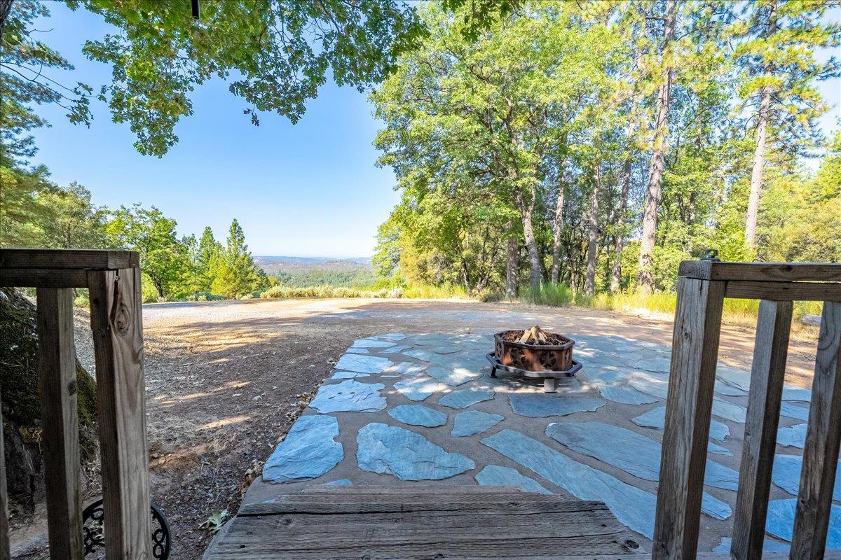 5595 Hackomiller Road Garden Valley, CA 95633 - Photo 12 of 42 a wooden bench sitting in front of a building