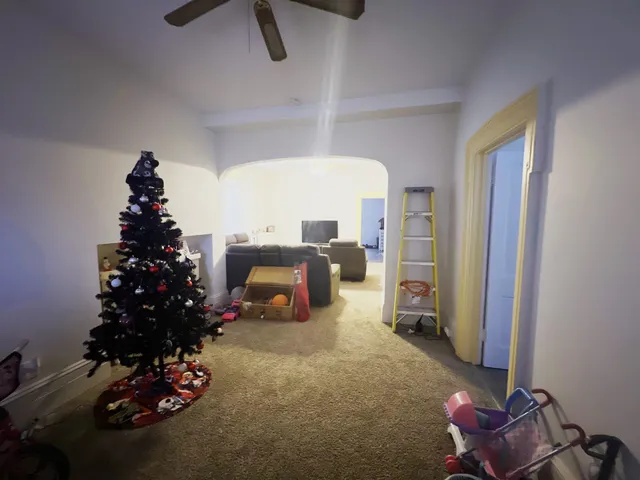 a living room with furniture and a christmas tree