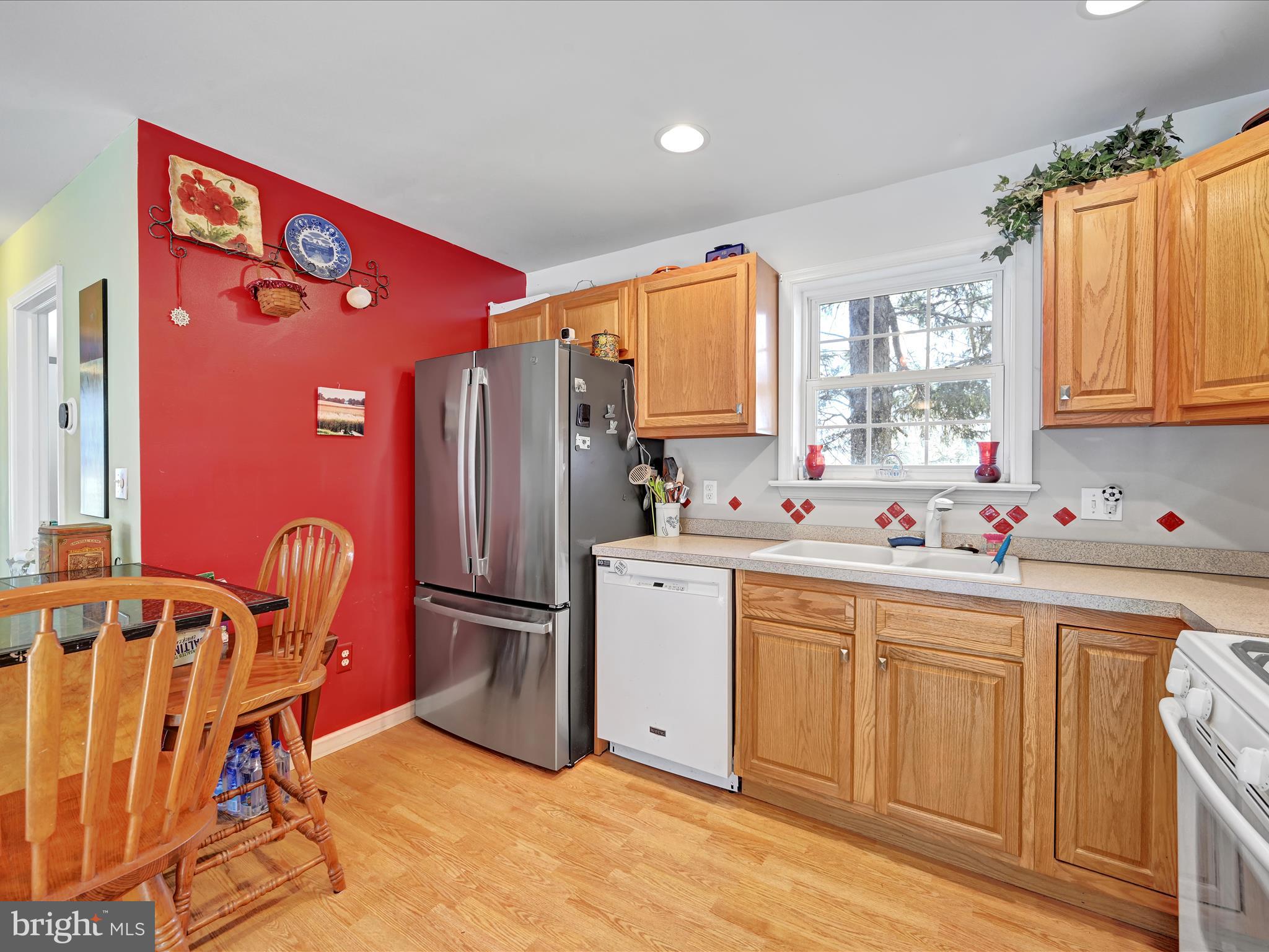 605 Wateredge Road Lititz, PA 17543 - Photo 10 of 29 a kitchen with stainless steel appliances granite countertop a refrigerator a sink dishwasher a dining table and chair with wooden floor
