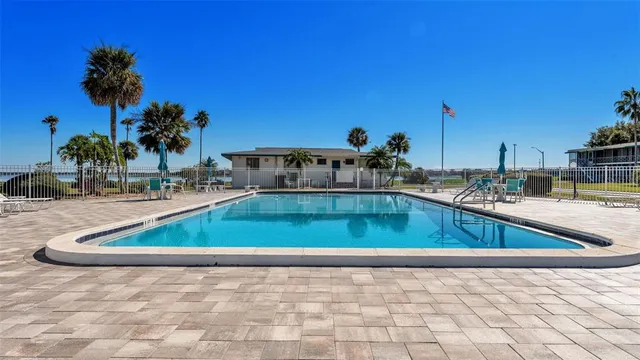 a view of swimming pool with outdoor seating and city view