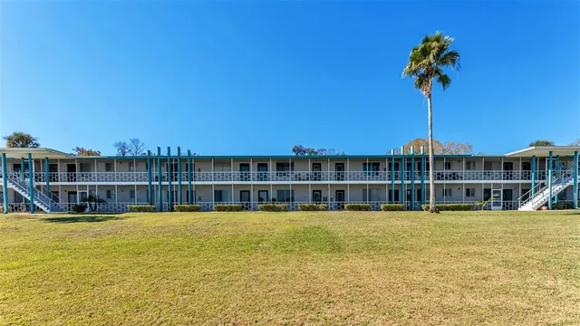 an aerial view of a house with a yard and lake view