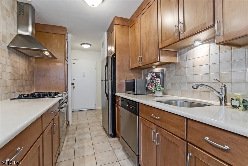 530 Valley Road, Unit 3L Montclair, NJ 07043 - Photo 12 of 25 a kitchen with a sink stove and cabinets