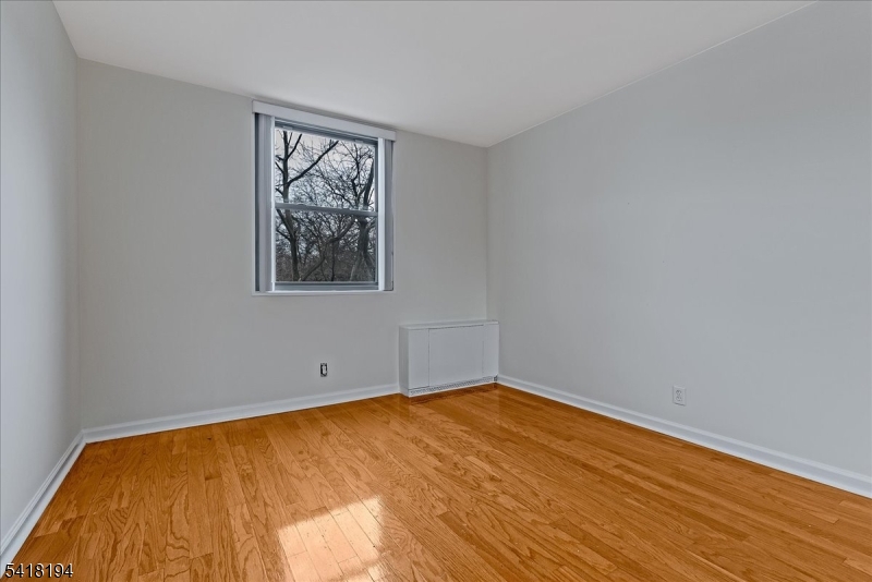 530 Valley Road, Unit 3L Montclair, NJ 07043 - Photo 19 of 25 a view of empty room with wooden floor