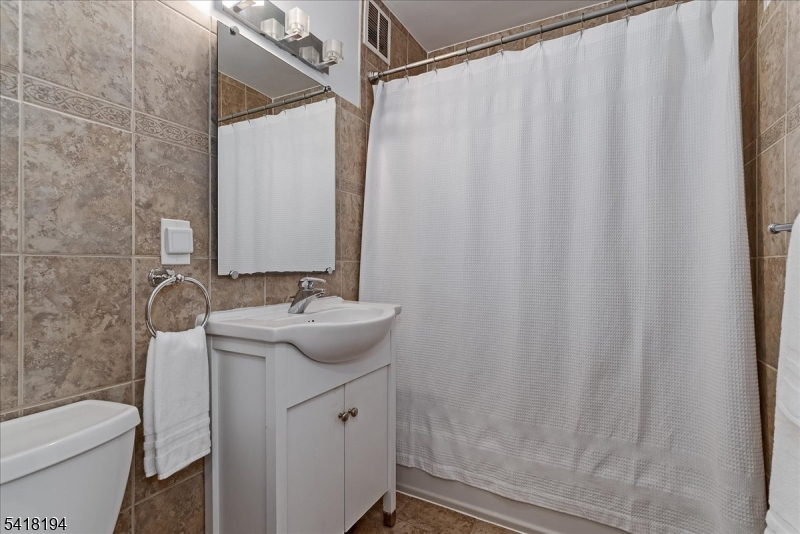 530 Valley Road, Unit 3L Montclair, NJ 07043 - Photo 20 of 25 a bathroom with a sink a toilet and shower