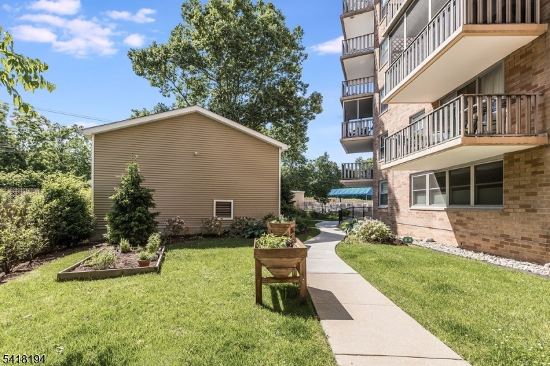 530 Valley Road, Unit 3L Montclair, NJ 07043 - Photo 24 of 25 a view of a house with backyard sitting area and garden