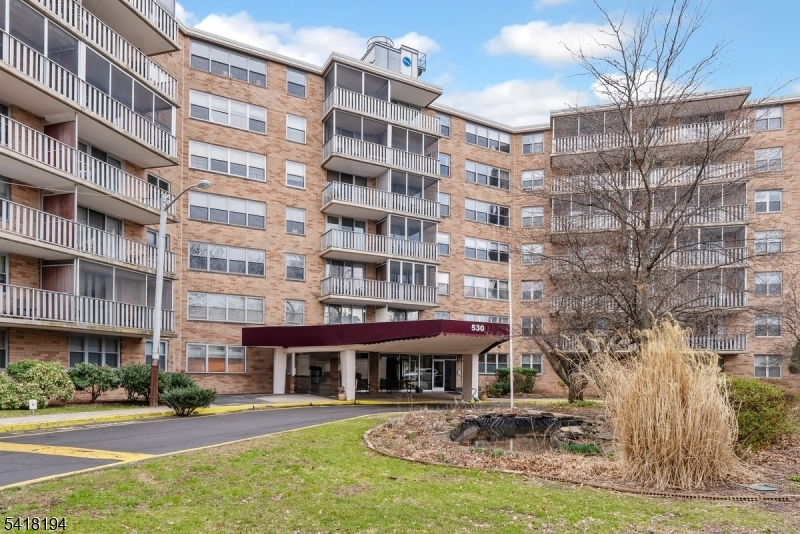 530 Valley Road, Unit 3L Montclair, NJ 07043 - Photo 25 of 25 a front view of a building with a garden and plants