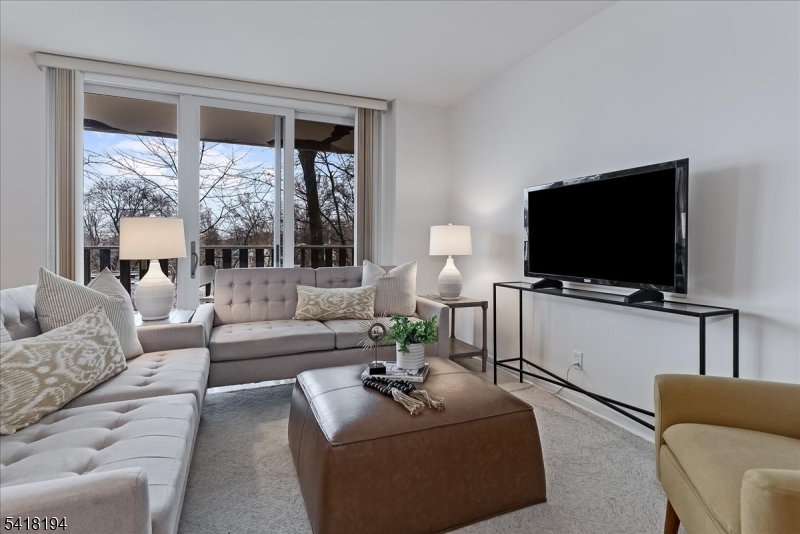 530 Valley Road, Unit 3L Montclair, NJ 07043 - Photo 4 of 25 a living room with furniture and a flat screen tv