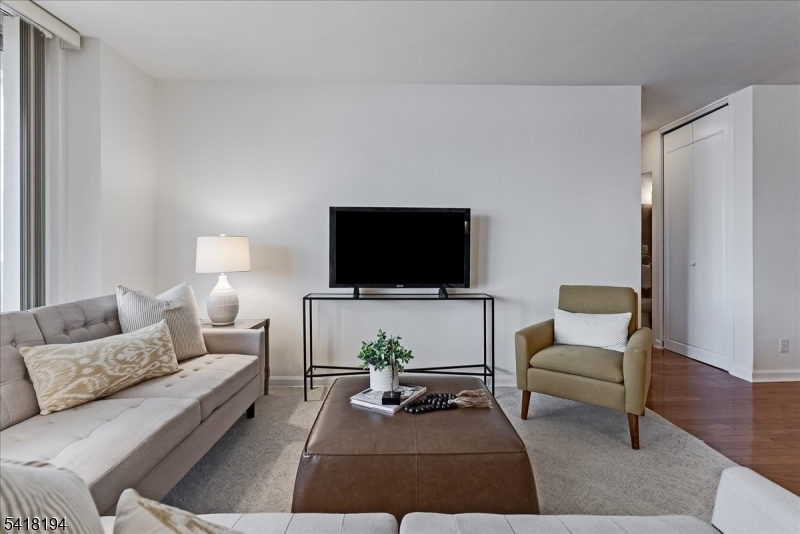 530 Valley Road, Unit 3L Montclair, NJ 07043 - Photo 5 of 25 a living room with furniture and a flat screen tv