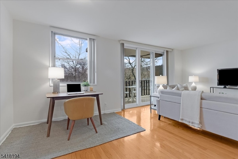 530 Valley Road, Unit 3L Montclair, NJ 07043 - Photo 8 of 25 a living room with furniture a flat screen tv and a window