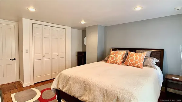 a bedroom with a bed and a mirror