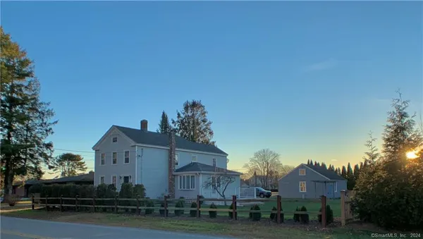 a view of house with a yard
