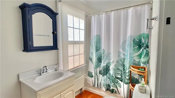a bathroom with a sink a mirror and a window