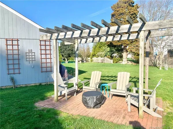 a view of a porch with furniture and garden